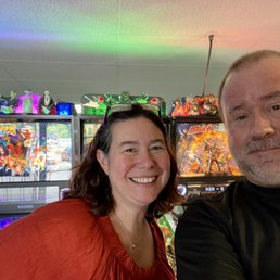 Patrons in front of several pinball machines. Patrons in front of several pinball machines.