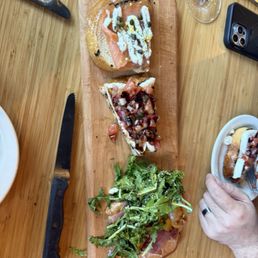Half eaten bruschetta board. Portion is huge! So yummy, we got the - smoked salmon, peach + prosciutto, and,mozzarella & tomato Half eaten bruschetta board. Portion is huge! So yummy, we got the - smoked salmon, peach + prosciutto, and,mozzarella & tomato