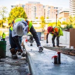 Pro-Pave - Pro-Pave Inc. Contractor Smoothing Concrete With a Float