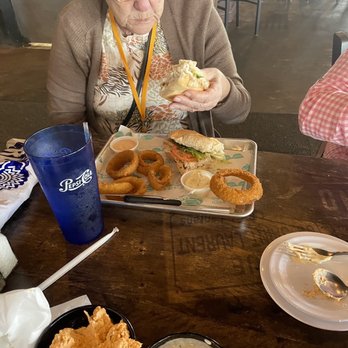 The Grumpy Monk - Fish sandwich with onion rings. - Bars Near Me - Myrtle Beach, South Carolina