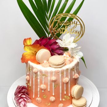 Cakes By Sabah - a cake decorated with macaroons and flowers - Custom Cakes Near Me Cakes By Sabah - a cake decorated with macaroons and flowers - Custom Cakes Near Me