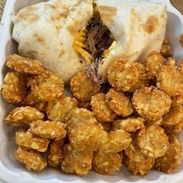 Brisket breakfast burrito ($13) and pork rubbed potato rounds ($7) Brisket breakfast burrito ($13) and pork rubbed potato rounds ($7)