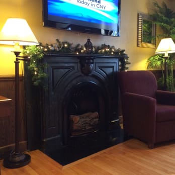 Beacon Hotel - Watching news in morning in comfortable living room chair, great coffee! - Hotels Near Me - Oswego, New York