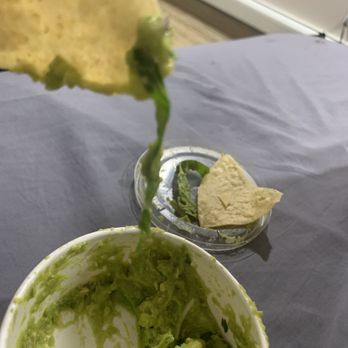 Chipotle Mexican Grill - guacamole being poured into a bowl - Mexican Near Me - Brooklyn, New York