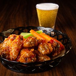 Island Grill - Saucy chicken wings served with fresh celery and carrots--classic, bold, and ready to devour.