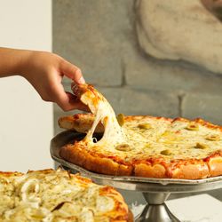 Mercado Buenos Aires - Freshly baked pizza with melted cheese, prepared for sharing.