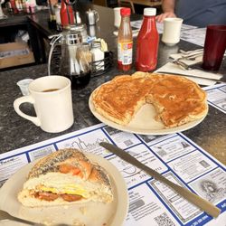 Sharon's Place - Egg cheese and hot sausage on a hard roll and a single banana pancake.