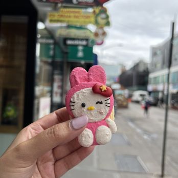 Mochiido - a hand holding a hello kitty toy - Donuts Near Me - Flushing, New York