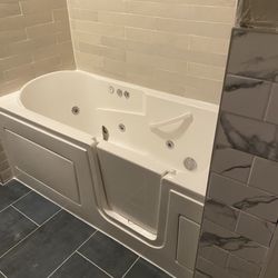 PNE Construction - Brand new whirlpool walk-in bathtub. Also showing off shower, floor and wall tiles.