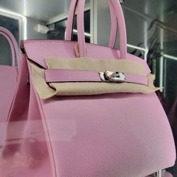 Gold and Beyond - Hermès Pink 35 Birkin Bag: Iconic design in vibrant pink. Luxurious leather craftsmanship meets functional elegance.