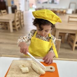 Shadowridge Montessori School - Educational Preschool in Shadowridge, Vista. Practical life activity cutting a banana independently #focus #fine motor skills.