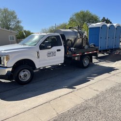 David & Son's Portable Toilets - truck hauling portable toilets