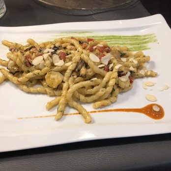 Cotto - Fresh pasta with octopus and a creamy pistachio basil sauce. - Italian Near Me - Rome, RM Cotto - Fresh pasta with octopus and a creamy pistachio basil sauce. - Italian Near Me - Rome, RM