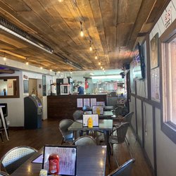 The Mad Hatter Saloon - Inside Madhadder! excited to try the great looking menu! Will definitely be back on the Harley!!! Back patio looks beautiful!!!