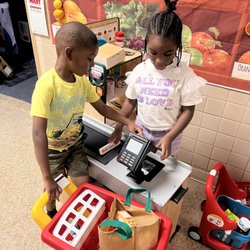 Children Of Purpose Stem Academy - Children engaged in "hands-on learning stations" and "manipulative centers." Learning through PLAY.