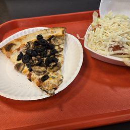 Pizza with black olives and mushrooms with a side salad Pizza with black olives and mushrooms with a side salad