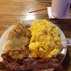 Alibi Pub & Grill - In house recipe cheesy garlic scrambled eggs w/ bacon and hash browns. YUM
