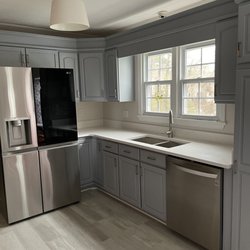 Our old brown cabinets painted gray and new dishwasher and refrigerator!