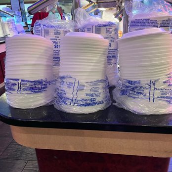 Buffet King - Multiple stacks of white disposable plates are placed on a black buffet counter at Buffet King in Austin, TX. - Chinese Near Me - Austin, Texas