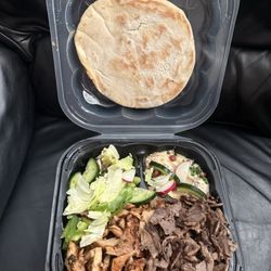 Mr Shawarma - Shawarma chicken and beef over rice. Salad and humus with pita bread in to go plate.