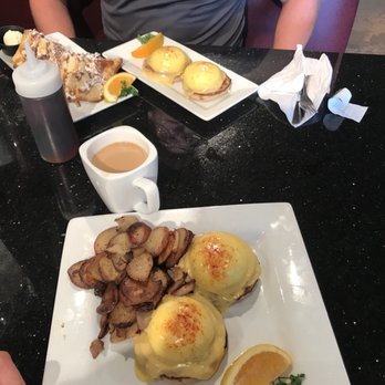 Keke's Breakfast Cafe - Eggs Benedict with Potatoes and across the table is the stufffed French Toast and Eggs Benedict. - Breakfast & Brunch Near Me - St Augustine, Florida Keke's Breakfast Cafe - Eggs Benedict with Potatoes and across the table is the stufffed French Toast and Eggs Benedict. - Breakfast & Brunch Near Me - St Augustine, Florida