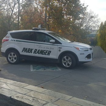 Discovery Meadow - Park ranger checking out the well-being of a sleeping homeless person - Parks Near Me - San Jose, California