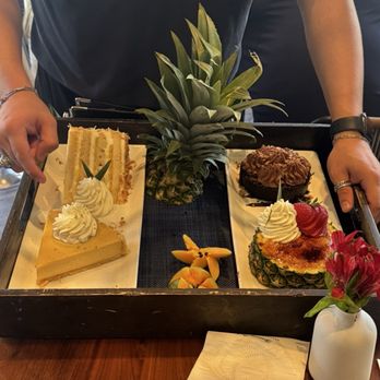 Tommy Bahama Restaurant & Bar - Dessert options - coconut pineapple cake (which I chose), key lime pie, crème brûlée in a pineapple, and a choc cake - Seafood Near Me - The Woodlands, Texas Tommy Bahama Restaurant & Bar - Dessert options - coconut pineapple cake (which I chose), key lime pie, crème brûlée in a pineapple, and a choc cake - Seafood Near Me - The Woodlands, Texas