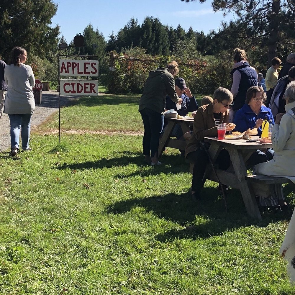 Baker Orchard - a group of people sitting at picnic tables - Fruits & Veggies Near Me - Centuria, Wisconsin