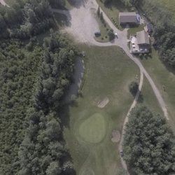 Grouse Nest Golf Course - Clubhouse, number 9 green and the beginning of hole 1