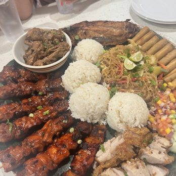 Tambayan - Family Plate- BBQ chicken skewers, pancit, lechon, pork Shanghai egg rolls, mango salsa, chicken adobo, milk fish, and rice - Filipino Near Me - Mesa, Arizona Tambayan - Family Plate- BBQ chicken skewers, pancit, lechon, pork Shanghai egg rolls, mango salsa, chicken adobo, milk fish, and rice - Filipino Near Me - Mesa, Arizona