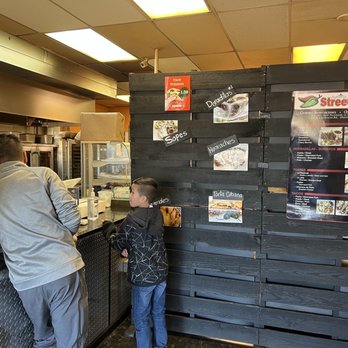 Street Tacos - a man and a child at a counter - Food Trucks Near Me - Olathe, Kansas