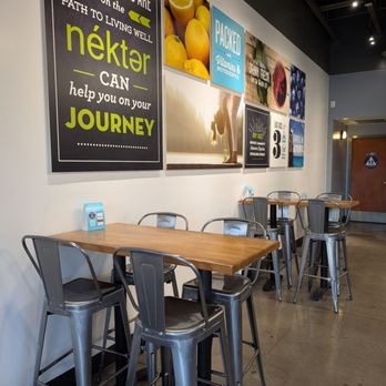 Nekter Juice Bar - Tables and chairs by the wall - Acai Bowls Near Me - La Habra, California Nekter Juice Bar - Tables and chairs by the wall - Acai Bowls Near Me - La Habra, California