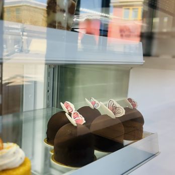 Sy's Sweet Dessert Bar - Chocolate mousse cake dome with edible butterfly accent. Yellow cake next to it was cream cheese filled- yum! - Bakeries Near Me - Las Vegas, Nevada Sy's Sweet Dessert Bar - Chocolate mousse cake dome with edible butterfly accent. Yellow cake next to it was cream cheese filled- yum! - Bakeries Near Me - Las Vegas, Nevada