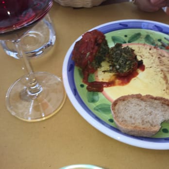 Tischi Toschi - Opened fennel ball with pine nuts, raisins, fennel, fennel seed with a fine tomato sauce, best dish, surprisingly craveworthy - Italian Near Me - Taormina, Maine