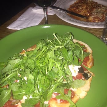 WILD - Pizza with eggplant, cherry tomatoes, mozzarella, goat cheese and topped with arugula tossed with EVOO, salt and pepper - New American Near Me - New York, New York WILD - Pizza with eggplant, cherry tomatoes, mozzarella, goat cheese and topped with arugula tossed with EVOO, salt and pepper - New American Near Me - New York, New York