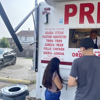 Primo's Tacos - two people ordering food from a food truck - Food Trucks Near Me - Detroit, Michigan