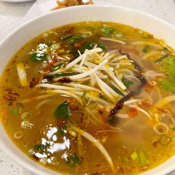 Pho Lee - a bowl of soup on a table - Vietnamese Near Me - London, Ontario