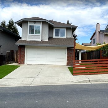 Ceiba Landscaping - a driveway with a fence and a house in the background - Landscaping Near Me Ceiba Landscaping - a driveway with a fence and a house in the background - Landscaping Near Me