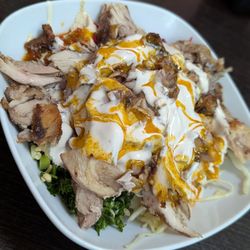 Mister laffa - Chicken shawarma in a plate over hummus and salads with tahini and amba sauces