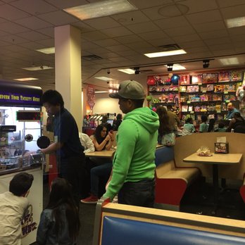 Chuck E. Cheese - A worker trying to fix the ticket redemption machine. - Pizza Near Me - Hayward, California Chuck E. Cheese - A worker trying to fix the ticket redemption machine. - Pizza Near Me - Hayward, California