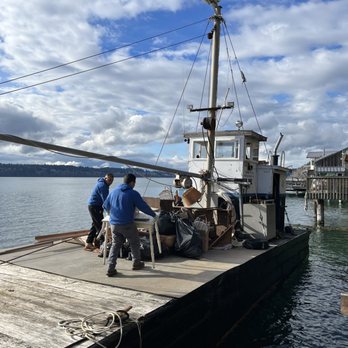 Junk Express - Junk Express moving items onto a boat. - Junk Removal & Hauling Near Me Junk Express - Junk Express moving items onto a boat. - Junk Removal & Hauling Near Me