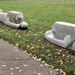 Pontiac Square Park - Whimsical lions (?) play ball with each other along a sidewalk.