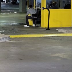 Hertz Rent A Car - This guy was sitting there with another employee. Doing nothing and waiting for cars.