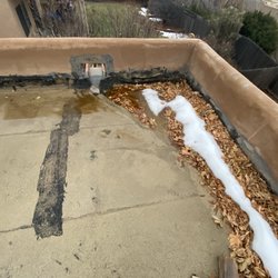 Richards Roofing - Lumps in roofing parapets trash. Roof obviously leaking and causing more damage.