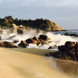 Club de playa Coco's - There are rocks on both sides of the beach making it a little cove like beach...