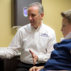 James C. Ross Family, Cosmetic & Laser Dentistry - Dr. James C. Ross helping a patient.