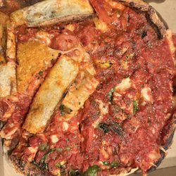 Marley's Pizzeria - Dropped pizza repacked into box. Note the piece that is upside down, folded over pieces, and edges of crust in the middle.