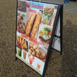 Folding placard sign next to the main road.