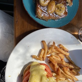 Harvest Kitchen - Shared an Eggs Benedict with tomato instead of bacon and Banana French Toast with my dining partner. This is my HALF of the meal! - New American Near Me - New York, New York