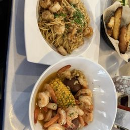 Garlic noodles with shrimp and peeled shrimp with corn and potatoes